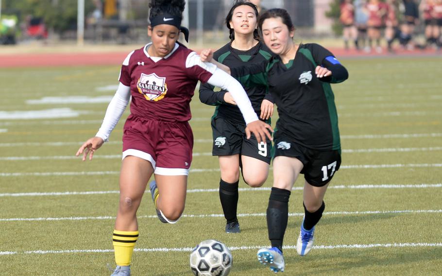 Matthew C. Perry's Ivanelis Nieves-Bermudez outraces Nagoya International's Otoha Yasui and Misaki Oyama for the ball during Friday's Western Japan Athletic Association girls soccer tournament. The Samurai won 3-1.