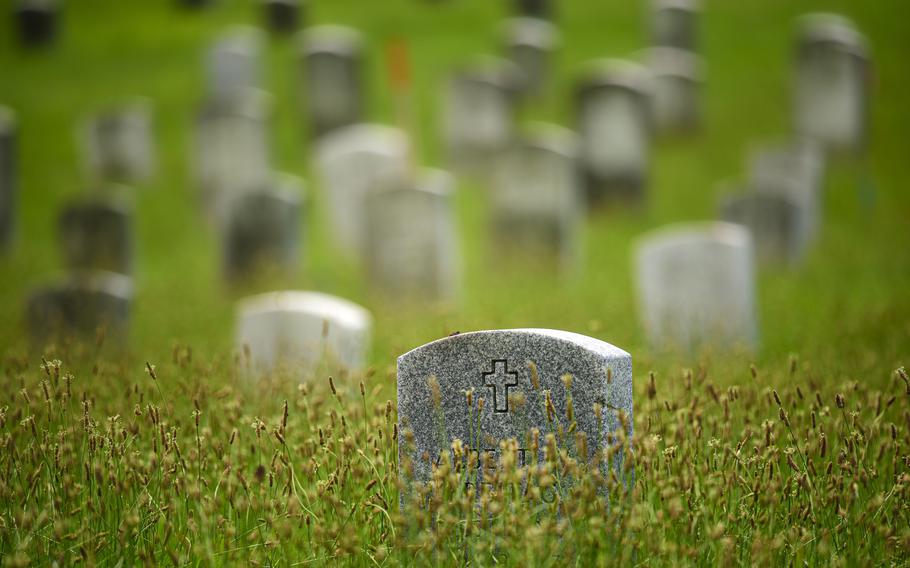 Headstones are surrounded by uncut grass at Northwood Cemetery/Soldiers Field in Windsor.