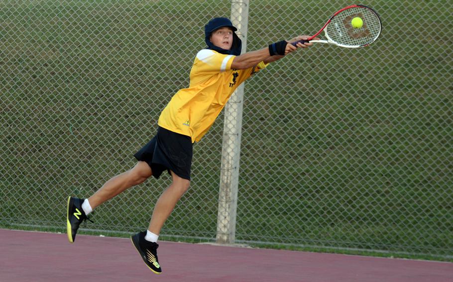 Kadena's Micah Berry lunges to make a two-hand backhand shot during Tuesday's Okinawa mixed-doubles tennis matches. Berry and Sydney Pontious beat Kubasaki's Jacy Fisk and Noemi Ung 9-8 (8-6) in a tiebreak, but the Dragons won as a team 5-1.