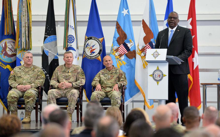 Chairman of the Joint Chiefs of Staff Mark Milley, Gen. Tod Wolters, outgoing commander of U.S. European Command, and Gen. Christopher Cavoli, the incoming commander, from left, listen to Defense Secretary Lloyd Austin during the EUCOM change of command ceremony, in Stuttgart, Germany, July 1, 2022. 