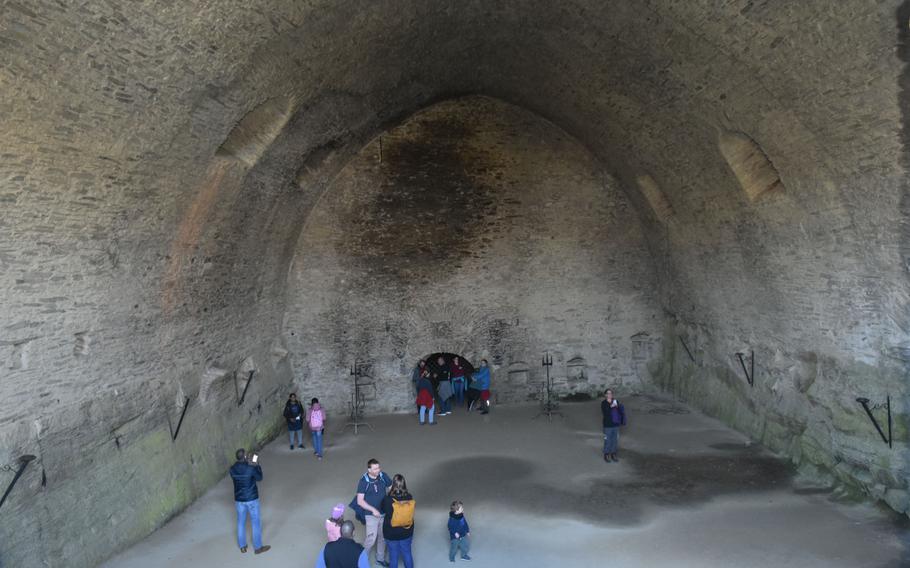 Visitors admire the vaulted ceiling of the cellar at Rheinfels Castle in St. Goar, Germany, April 16, 2022. With an area of more than 3,000 square feet, the room is considered Europe’s largest self-supporting vaulted cellar and once housed a wine barrel with a capacity of over 45,000 gallons. 