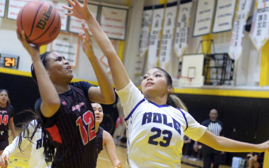 Kinnick's KaMiyah Dabner shoots against Academy's Mia Topasna.