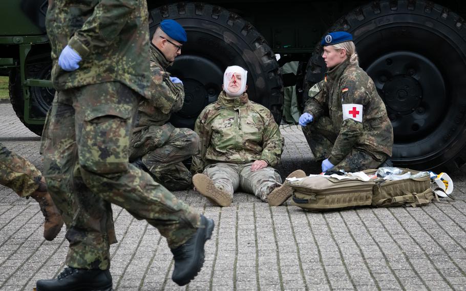 U.S. Army Sgt. Mary Lapp pretends to be injured during a demonstration at a military base outside Cologne, Germany, Oct. 23, 2023. 