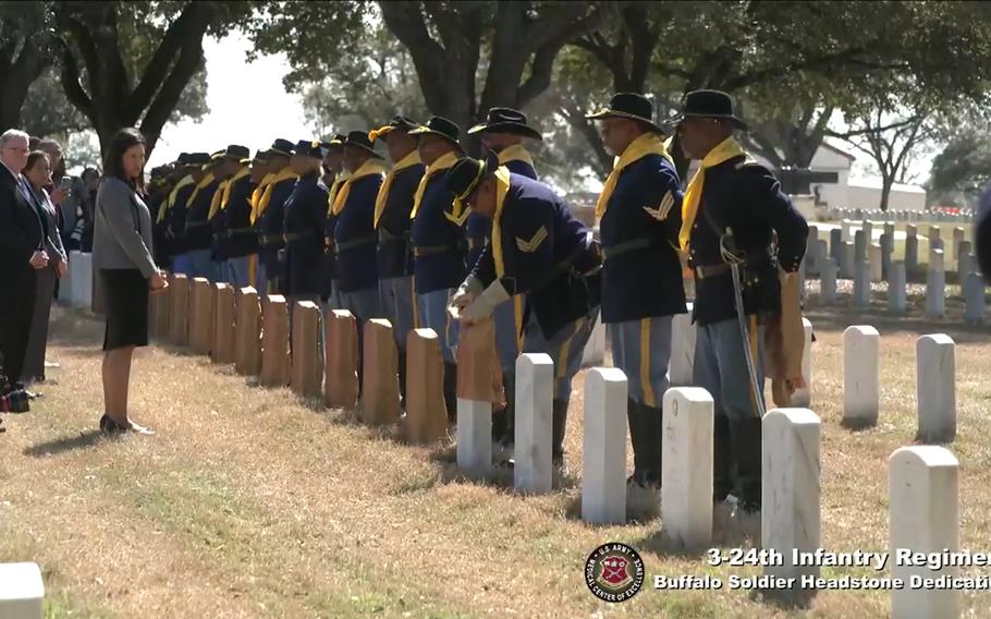 In this screenshot from video, Tanya Bradsher, deputy secretary of the Department of Veterans Affairs, watches on Feb. 22, 2024, as new headstones are unveiled for 17 Black soldiers buried at Fort Sam Houston National Cemetery in San Antonio, Texas. The men were executed following the 1917 Houston Riots. The Army overturned the convictions last year and the men were granted honorable discharges.