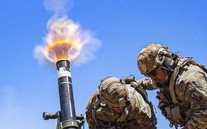 Army Col. Randy Lau fires a 120 mm mortar during a live-fire exercise at Camp Roberts, California, June 15, 2021.