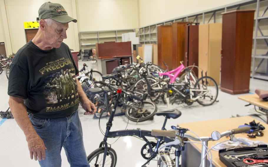 Army veteran Daniel Melton prepares to fix another abandoned bicycle at Camp Humphreys, South Korea, Sept. 12, 2023. 