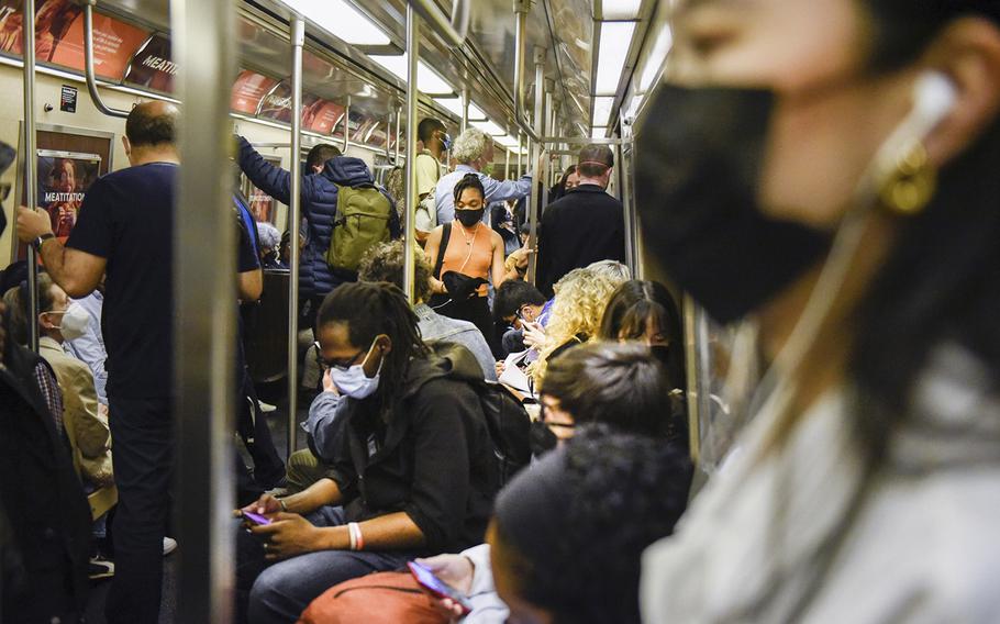 Commuters ride a subway in New York on May 25, 2022. 