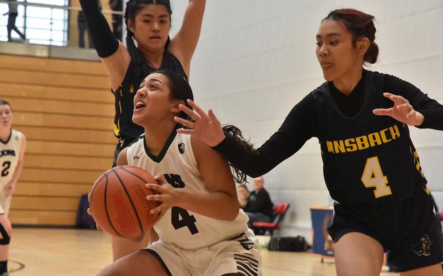 AFNORTH’s Selah Skariah tries to find an opening while Ansbach’s Kylah Tuazon closes in Thursday, Feb. 15, 2024, at the DODEA European Division III Basketball Championships at Wiesbaden, Germany.