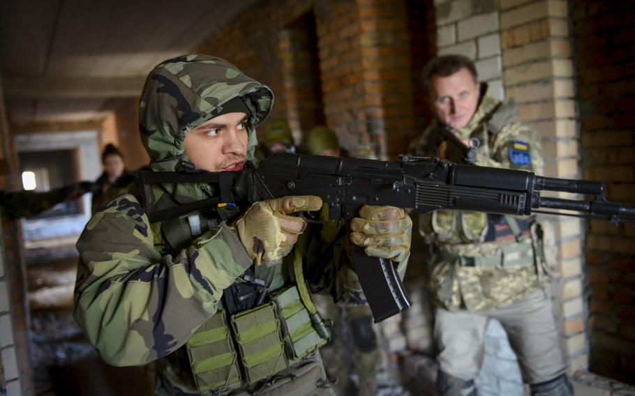 A member of the Ukrainian Territorial Defense Forces on Nov. 2, 2022, clears a hallway as part of training at an abandoned building outside Kyiv, Ukraine. 