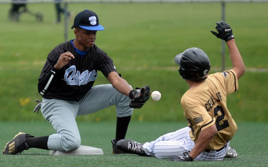 Humphreys' Ceser Celis gets the first of his three stole bases, sliding into second as Cougars shortstop Jaylon Grant can't find the handle on the throw.