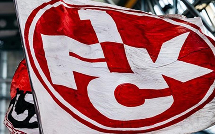 A Kaiserslautern soccer flag says 1FCK printed in white on a red circle.