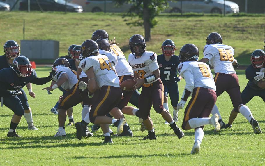 Senior QB Aron Atakuzi hands the ball off to senior running back Junior DeJesus during Vilseck’s football game against Lakenheath on Friday, Sept. 15 in Vilseck, Germany.