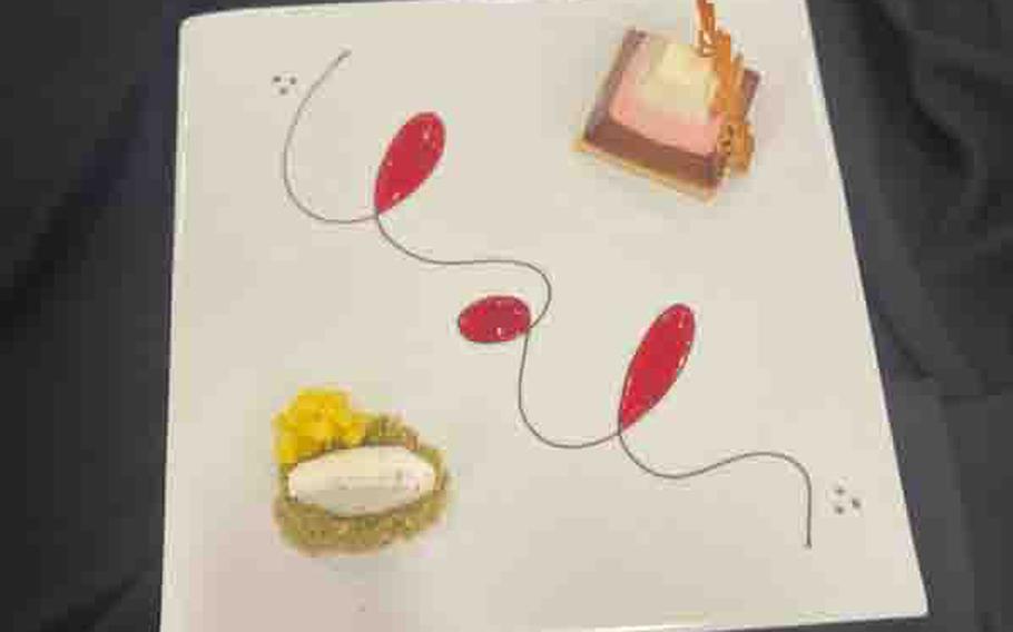 Neapolitan pyramid mousse served with vanilla bean ice cream on top of pistachios and mangoes at the 48th Joint Culinary Training Exercise in the MacLaughlin Fitness Center on Fort Gregg-Adams, Va., March 8, 2024.