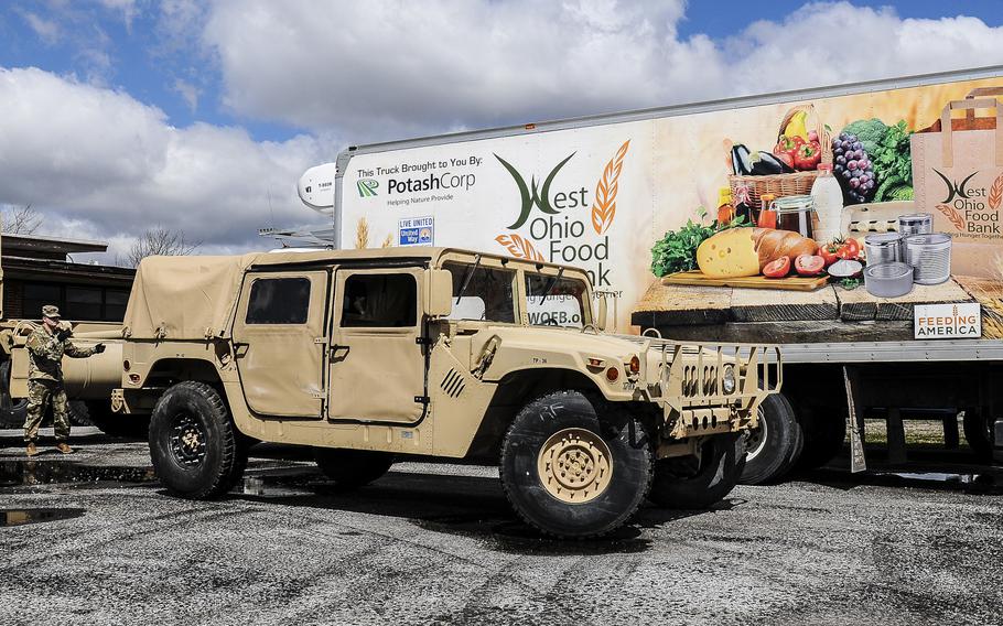 Soldiers of the Ohio National Guard’s 237th Support Battalion and 1st Battalion, 148th Infantry Regiment prepare to distribute food April 2, 2020, in Kenton, Ohio.  About 40 Ohio National Guard members will respond to Dayton to help with hospital staffing shortages related to the COVID-19 pandemic.