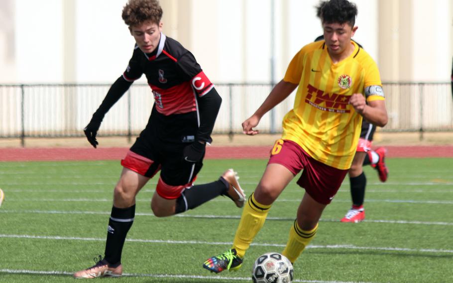 E.J. King's Kai Sperl chases Matthew C. Perry's Ren Spinosi for the ball during Saturday's Perry Cup Silver Group playoff. The teams tied 0-0.