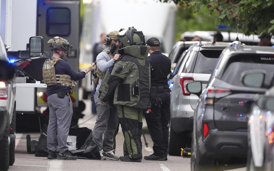 Law enforcement officials dress up in protective gear.