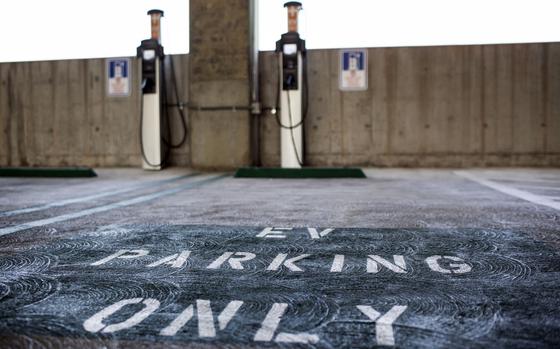 A sign reading "EV Parking Only" is seen on the ground in front of ChargePoint electric vehicle charging stations in a municipal parking lot in Los Angeles, Calif., on July 11, 2017. MUST CREDIT: Bloomberg photo by Dania Maxwell.