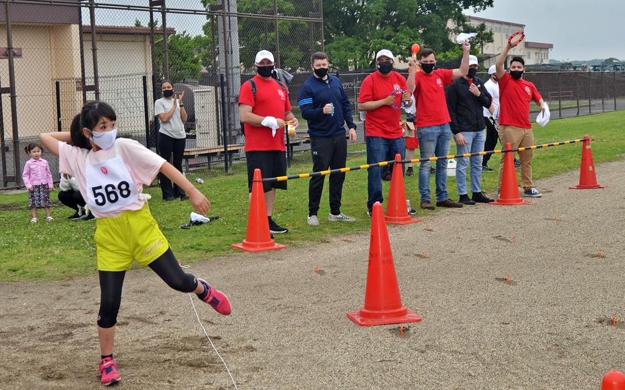 Volunteers cheer on a competitor in the Kanto Plains Special Olympics at Yokota Air Base, Japan, Saturday, May 22, 2021. 