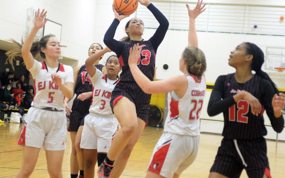 Nile C. Kinnick's Amyka Jones drives to the basket against E.J. King during Saturday's third-place game in the 5th American School In Japan Kanto Classic basletball tournament. The Red Devils outlasted the Cobras 51-45.