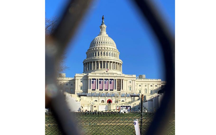 The U.S. Capitol is seen through a security fence on Jan. 12, 2021.