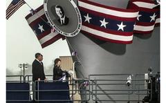 Sandra Jontz/Stars and Stripes
Newport News, Va., March, 2001: With a firm, two-handed grip, former first lady Nancy Reagan smashes the ceremonial bottle of champagne against the hull of the Nimitz-class aircraft carrier christened in the name of her husband, Ronald Reagan. The ceremony, attended by President George W. Bush, was held on the couple's 49th wedding anniversary at Nancy Reagan's request.