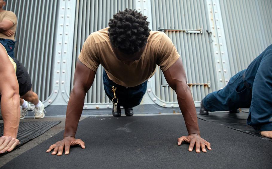 Sailors take a mock physical fitness assessment aboard the guided-missile destroyer USS Halsey in the Arabian Sea, Aug. 27, 2021. 