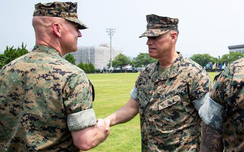 Maj. Gen. Brian Wolford, right, head of Marine Corps Installations Pacific, congratualates Col. Kenneth Rossman, the new commander of Marine Corps Air Station Iwakuni, Japan, July 2, 2025. 