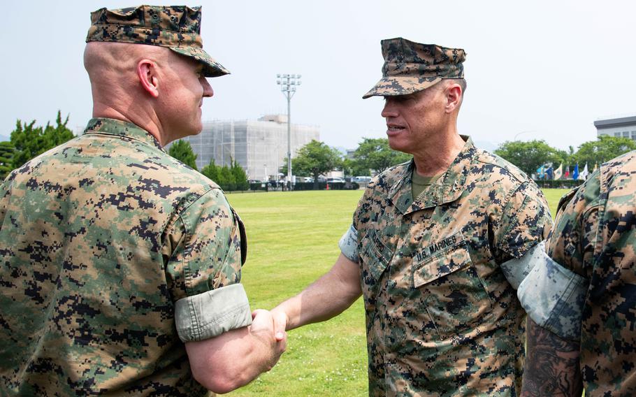 Maj. Gen. Brian Wolford shakes hands with Col. Kenneth Rossman.