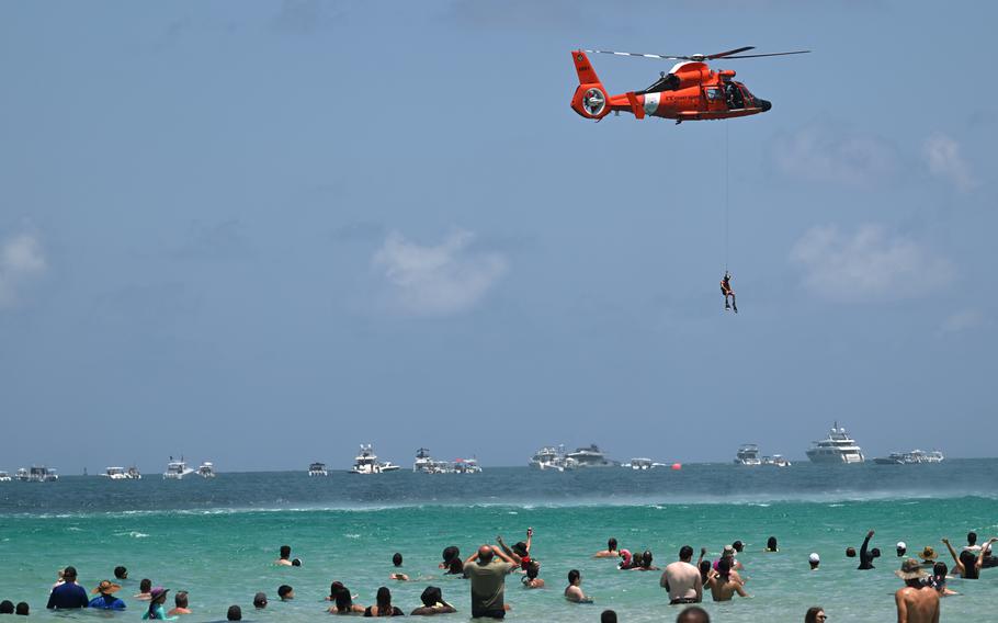 An aviation survival technician hoists from a MH-65 Dolphin Helicopter 