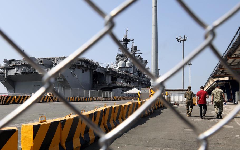 The amphibious assault ship USS America docks at Manila's South Harbor, Tuesday, March 21, 2023.