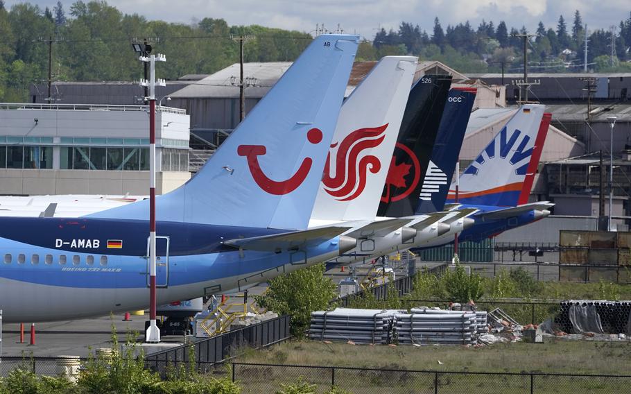 Boeing 737 Max airplanes, including one belonging to TUI Group, left, sit parked at a storage lot, Monday, April 26, 2021, near Boeing Field in Seattle.  