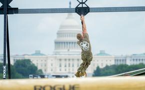 A soldier climbs to the top of a rope while competing in an Army fitness test held on the National Mall in Washington on June 14, 2025 during the service’s 250th birthday festival. (Corey Dickstein/Stars and Stripes)
