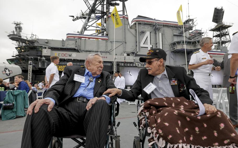 Battle of Midway veterans Ervin "Judge" Wendt, 106, USN (Ret.) left, and Aviation Radioman 1st Class Charles Monroe, 98, who were both with USN Torpedo Squadron Eight during the Battle of Midway, await the start of the commemoration ceremony of the 80th anniversary of the Battle of Midway and the Centennial of U.S. Navy Aircraft Carriers at the USS Midway Museum in San Diego on June 4, 2022. 