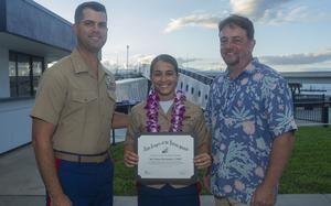 U.S. Marine Corps Sgt. Yliana A. Hernandez, center, receives the Navy League Sea Service Award from Lt. Col. Jeremy B. Smith, left, during the 2021 Navy League Sea Service Awards luncheon at the Pacific Fleet Museum Bowfin Lanai, Honolulu, Hawaii, Nov. 18, 2021. Hernandez is one of three Marines who have died at Parris Island in the last two-and-a-half months.