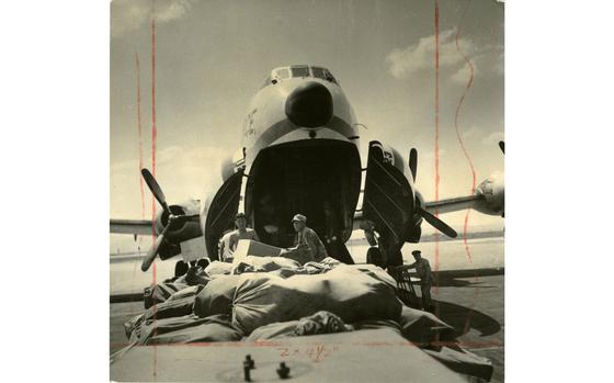 Kimbo Air Base, South Korea, Aug. 26, 1956:  Mail gets unloaded from an Air Force Globemaster at Kimbo Air Base, South Korea. The Army Postal Service delivered more than four million pounds of mail and packages to Korea-based soldiers in the first six months of 1956. 

If you look closely at this photograph, you can see the red edit marks made by the photo editor to indicate how the image should be cropped and published in the printed paper. The Pacific Stars and Stripes - which published its first issue in 1945 -  lost all of its pre-1964 negatives during a move to new locations that year, so the prints of the images that were published in the paper are the only originals we have left. As part of our preservation efforts, Stars and Stripes' archives staff has begun their digitization. All prints are scanned twice: once in full color, with the edit marks, once in B&W, without the edit marks. 

Looking for Stars and Stripes’ historic coverage? Subscribe to Stars and Stripes’ historic newspaper archive! We have digitized our 1948-1999 European and Pacific editions, as well as several of our WWII editions and made them available online through https://starsandstripes.newspaperarchive.com/

META TAGS: U.S. Army; postal service; military; life; military mail; U.S. Air Force. C-124 Globemaster; plane; aircraft