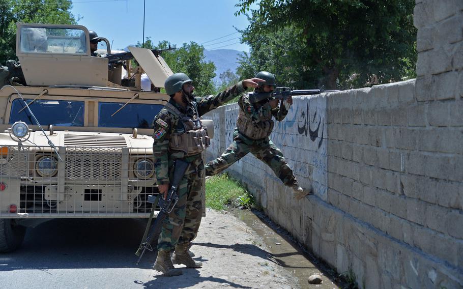 Members of Afghan security forces take their positions during an ongoing clash between Taliban and Afghan forces in Mihtarlam, the capital of Laghman Province, on May 24, 2021, as the insurgents pressed on with their campaign to seize new territories as the U.S. military continued with its troop pullout. 