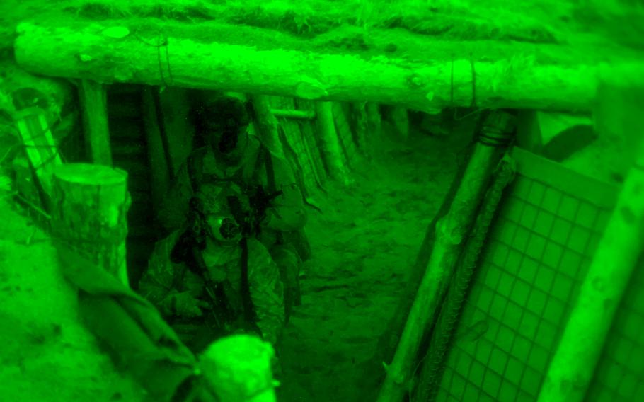 Army Airborne going through trenches for a training exercise.