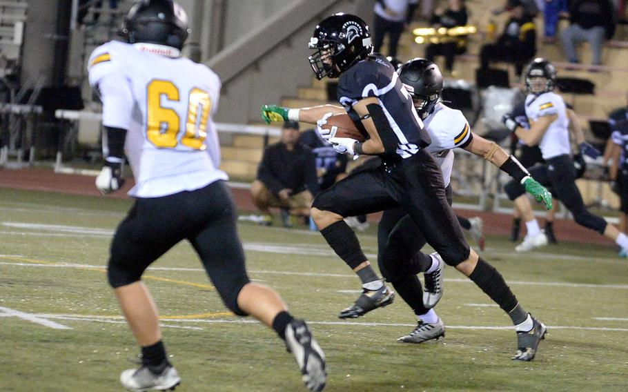 Zama receiver Keahnu Araki looks for room to run against American School In Japan defenders.