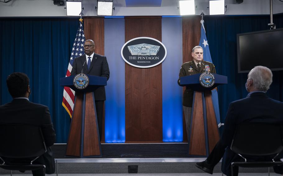 Defense Secretary Lloyd Austin, left, and Army Gen. Mark Milley, chairman of the Joint Chiefs of Staff, speak during a news briefing at the Pentagon on Wednesday, Aug. 18, 2021.