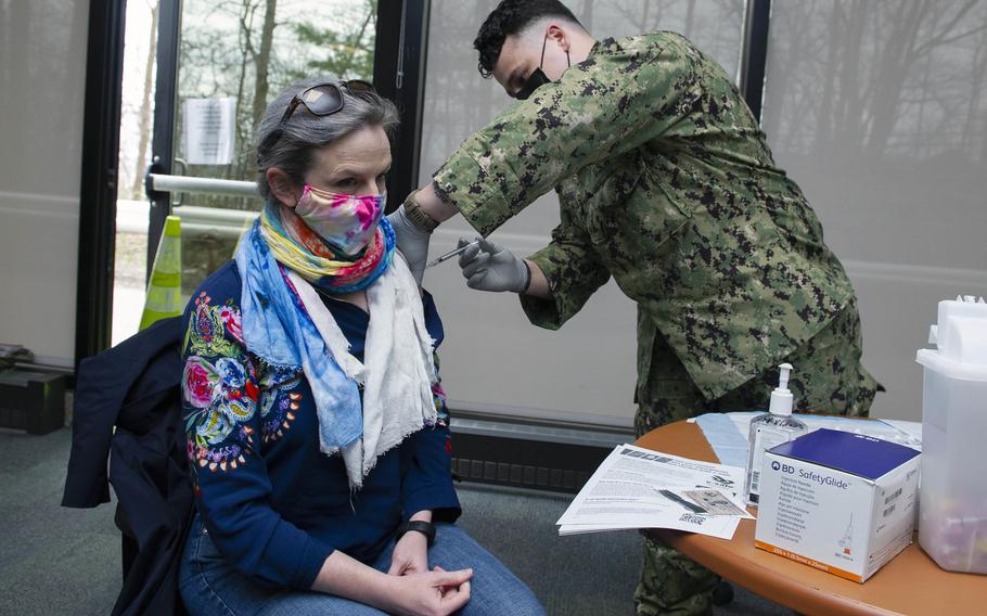Hospitalman Ethan Orshanski administers a coronavirus vaccine to Cynthia Miller at Navy Medicine Readiness and Training Unit Groton at Naval Submarine Base New London, Conn., on April 12, 2021.