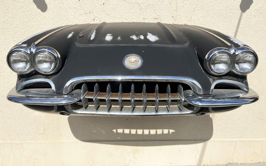 The front of a classic car is displayed on a wall outside the Route 16 diner at Yokota Air Base, Japan. 