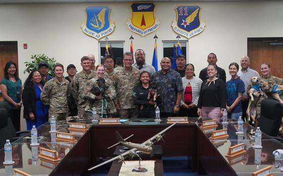 A group of U.S. military members and Guam government officials pose for a photo.