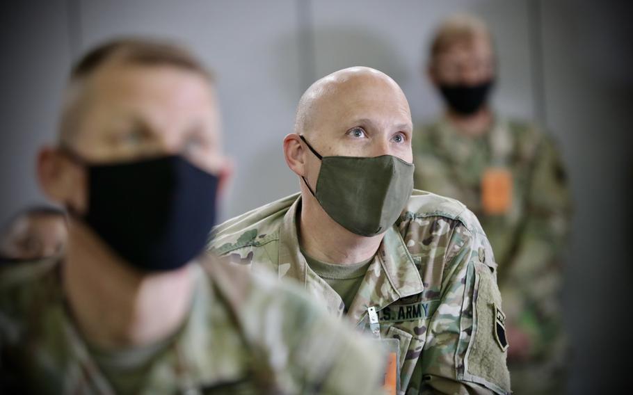 Army Reserve Col. Reece Roberts listens to a commander at Camp Williams, Utah, in 2021. 