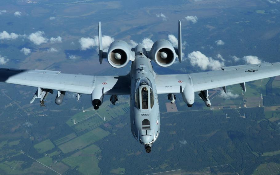 An A-10 Thunderbolt II, known as the “Warthog,” from Whiteman Air Force Base, Missouri, flies next to a KC-135 Stratotanker assigned to RAF Mildenhall, England, Sept. 9, 2015, over Estonia. The Air Force is looking to get rid of 150 aircraft, including 21 Warthogs, according to its proposed $169.5 billion budget for fiscal year 2023 released Monday, March 28, 2022.