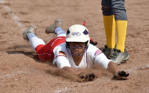 Kaiserslautern senior Giada Taylor slides into home plate during the first game of a doubleheader against Wiesbaden on April 26, 2025, at Kaiserslautern High School in Kaiserslautern, Germany.