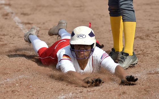 Kaiserslautern senior Giada Taylor slides into home plate during the first game of a doubleheader against Wiesbaden on April 26, 2025, at Kaiserslautern High School in Kaiserslautern, Germany.