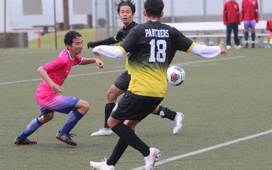 Nile C. Kinnick's Yuta Raqueno tries to go after the ball between Kadena's Gabriel Cedeno and Will Wetherill.