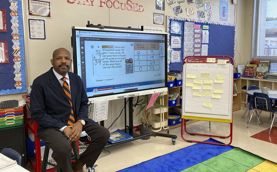 Second-grade teacher Nathan Rogers poses in his classroom at Shirley Lanham Elementary at Naval Air Facility Atsugi, Japan, Wednesday, Oct. 19, 2022.