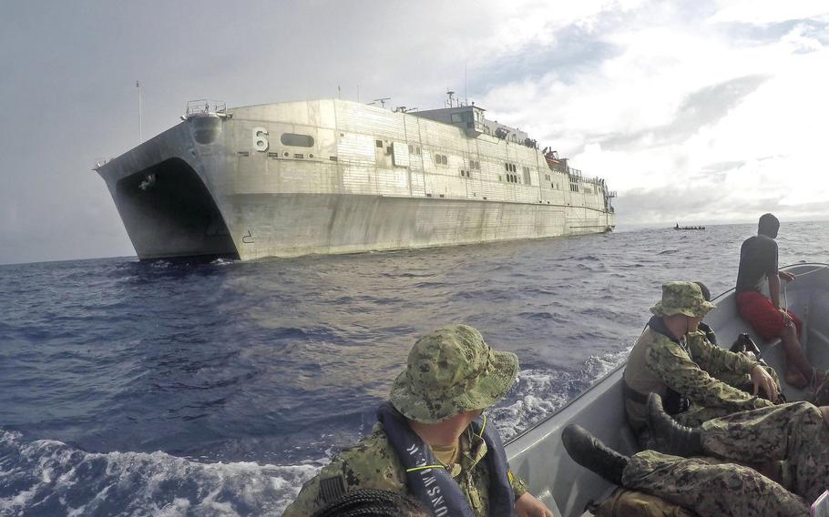 U.S. sailors conducting small boat operations approach the USNS Brunswick, a fast-transport ship, in April 2019 near Polowat of the Federated States of Micronesia in the Indo-Pacific region. 