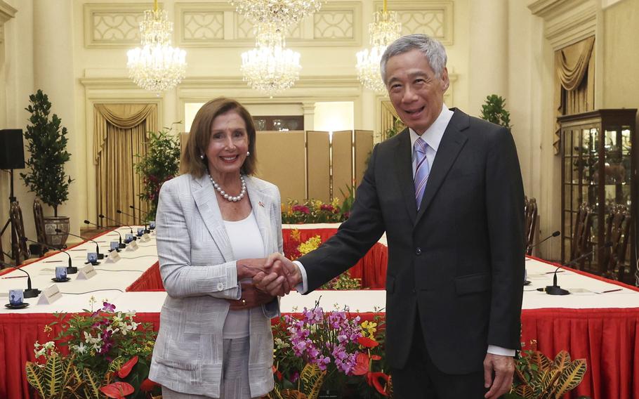 U.S. House Speaker Nancy Pelosi, left, and Prime Minister Lee Hsien Loong of Singapore shake hands at the Istana Presidential Palace in Singapore, Monday, Aug. 1, 2022.   